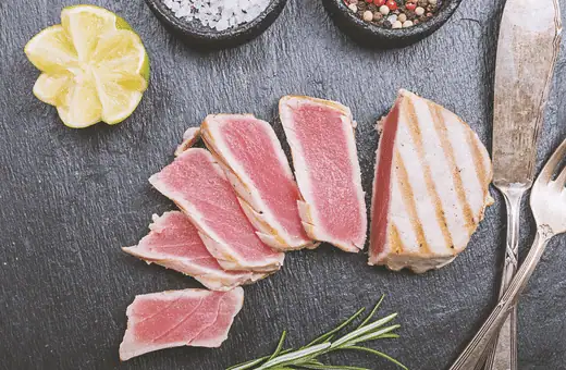 Tuna steak is one of the most famous seafood items on restaurant menus. It has a firm, pinkish-red flesh with a mild flavor. When cooked properly, tuna steak is moist and flaky